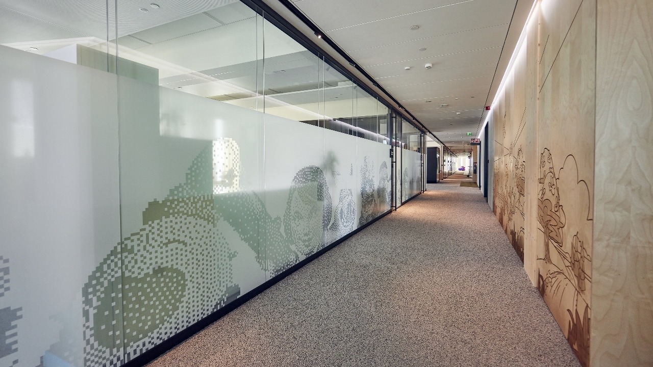 Supercell office hall with veneer wall.